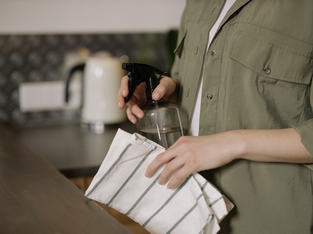 Woman cleaning kitchen counter