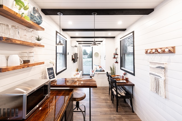 A compact living kitchen in a tiny house with wood floors.